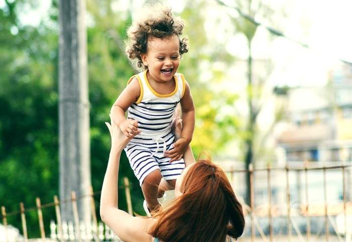 Mother and her child playing together